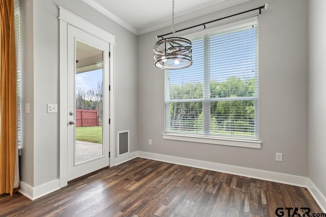 228 Smith Cir, Lindale, TX 75771 - unfurnished dining area featuring a chandelier, crown molding, and dark wood-style floors