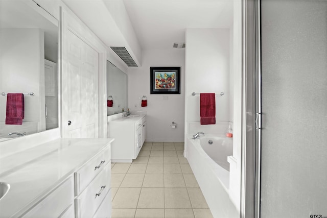 bathroom with visible vents, a sink, a bath, tile patterned floors, and two vanities