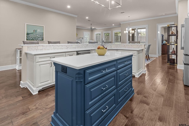 kitchen featuring blue cabinetry, white cabinetry, a large island, pendant lighting, and ceiling fan with notable chandelier