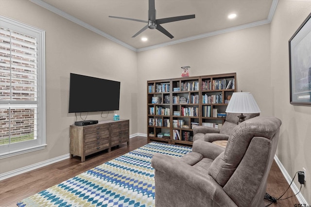 living room with hardwood / wood-style floors, ceiling fan, and crown molding