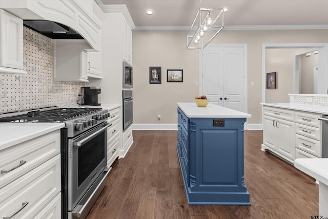 kitchen featuring blue cabinetry, white cabinetry, appliances with stainless steel finishes, a kitchen island, and ornamental molding