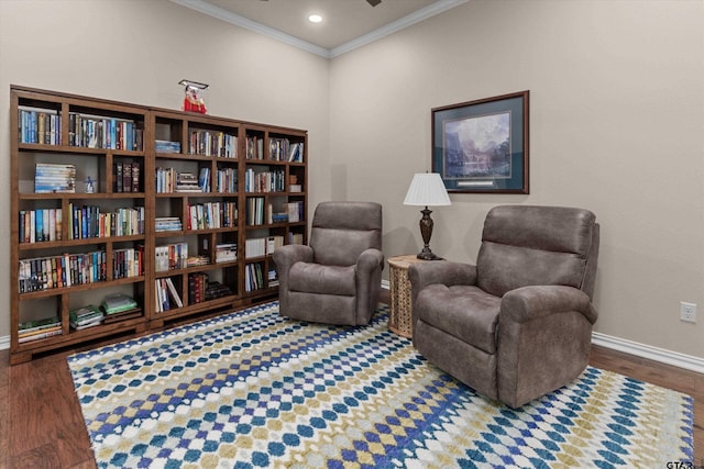 sitting room featuring ornamental molding and dark wood-type flooring