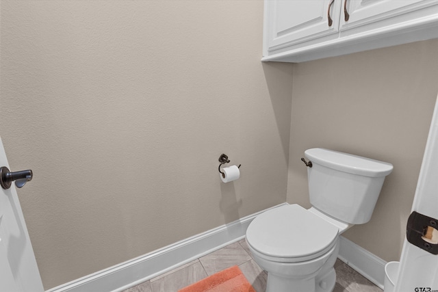 bathroom with tile patterned floors and toilet