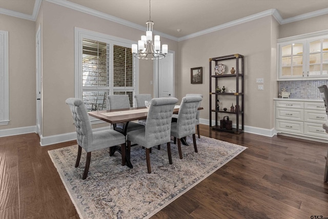 dining space with dark hardwood / wood-style floors, an inviting chandelier, and crown molding