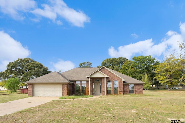 view of front of property with a garage and a front lawn