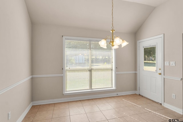 unfurnished dining area featuring a chandelier, plenty of natural light, light tile patterned floors, and lofted ceiling