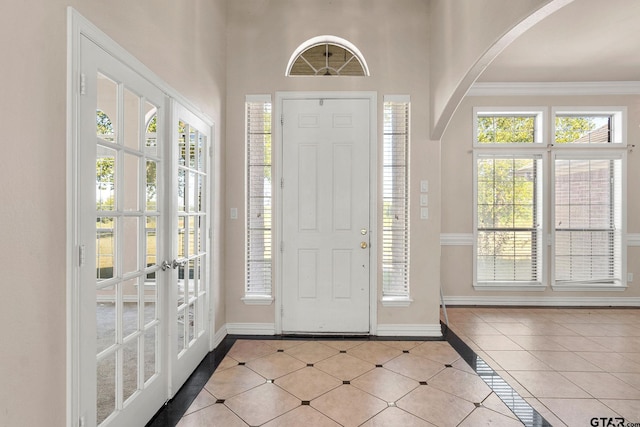 foyer entrance featuring french doors and ornamental molding