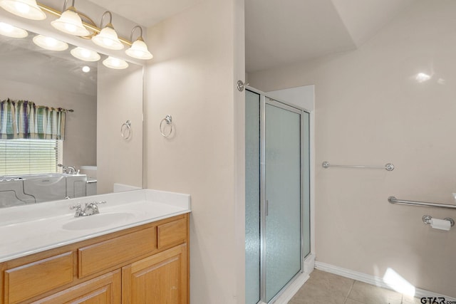 bathroom featuring tile patterned flooring, vanity, and a shower with shower door