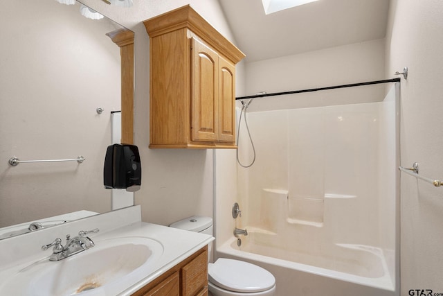 full bathroom with toilet, washtub / shower combination, vanity, and vaulted ceiling with skylight