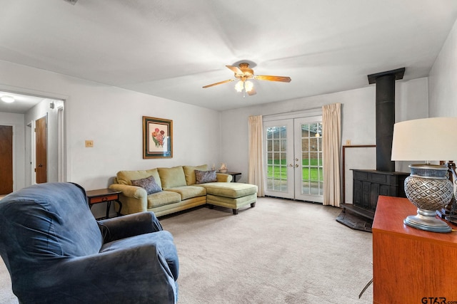 616 Golfcrest Dr, Longview, TX 75604 - living area with a wood stove, carpet flooring, ceiling fan, and french doors