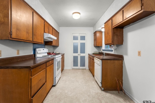 616 Golfcrest Dr, Longview, TX 75604 - kitchen featuring white appliances, under cabinet range hood, dark countertops, and brown cabinets