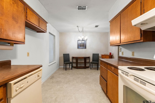 616 Golfcrest Dr, Longview, TX 75604 - kitchen featuring white appliances, under cabinet range hood, brown cabinets, a chandelier, and dark countertops