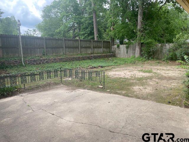 view of yard with a patio and fence