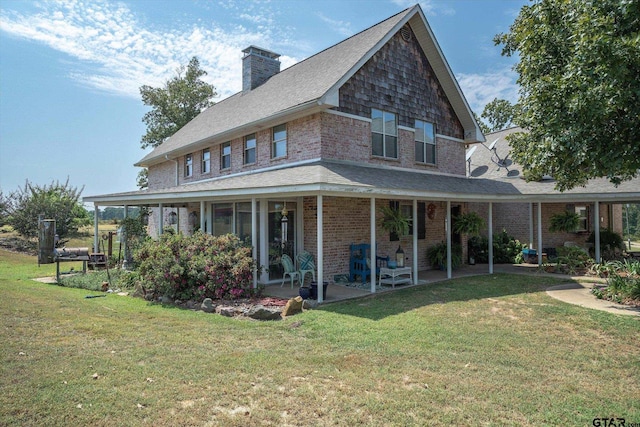 rear view of property featuring a porch and a yard