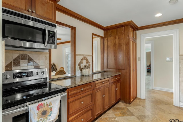 kitchen featuring crown molding, appliances with stainless steel finishes, tasteful backsplash, and light stone counters