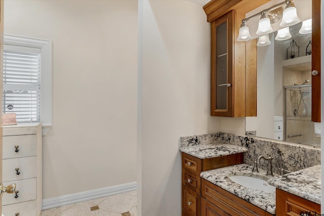 bathroom with vanity, tile patterned floors, and a shower with door