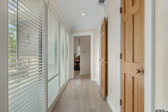 hall featuring ornamental molding and light wood-type flooring