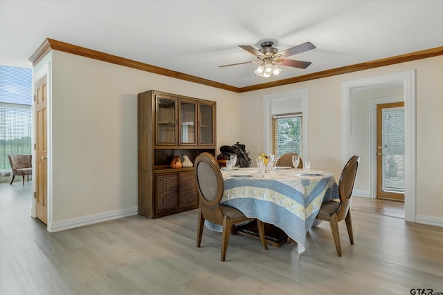 dining space featuring light wood-type flooring, ceiling fan, and ornamental molding