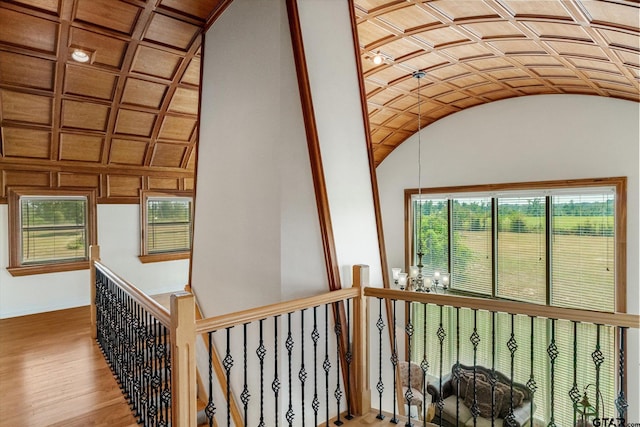 corridor featuring hardwood / wood-style floors and lofted ceiling