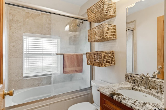 full bathroom with toilet, vanity, and shower / bath combination with glass door