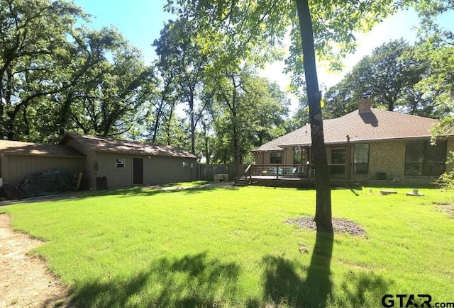 view of yard featuring a wooden deck and fence