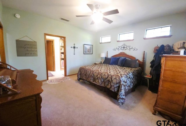 bedroom featuring multiple windows, ceiling fan, visible vents, and light colored carpet