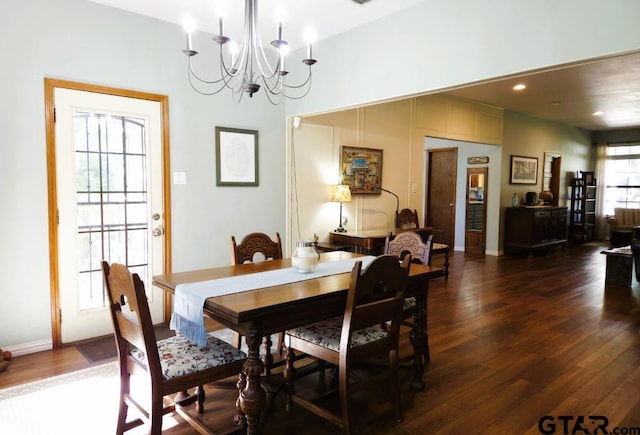dining space with a chandelier, baseboards, and dark wood-style floors