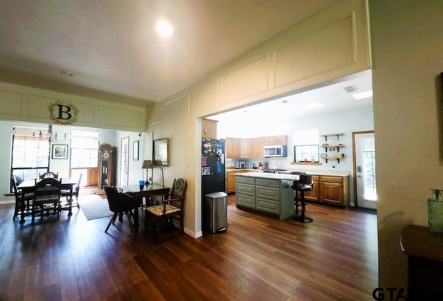 dining space with dark wood finished floors and visible vents