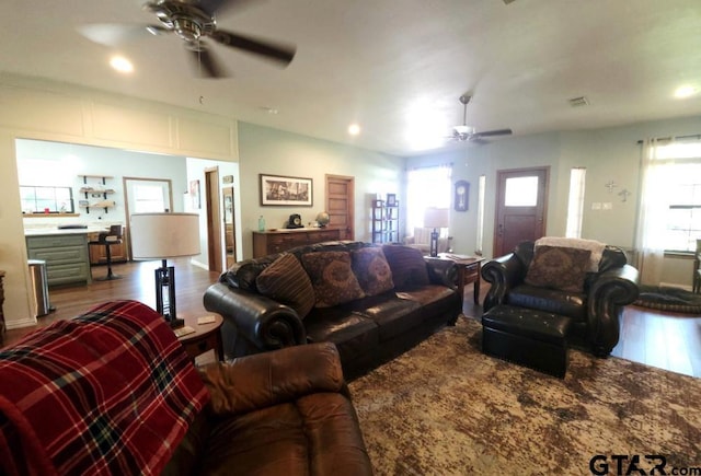 living area with wood finished floors, a ceiling fan, a healthy amount of sunlight, and recessed lighting