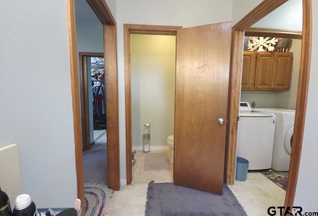 bathroom featuring toilet and independent washer and dryer