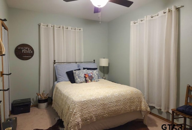 bedroom with a ceiling fan and carpet floors