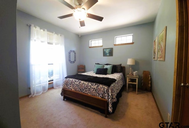 carpeted bedroom featuring a ceiling fan and baseboards