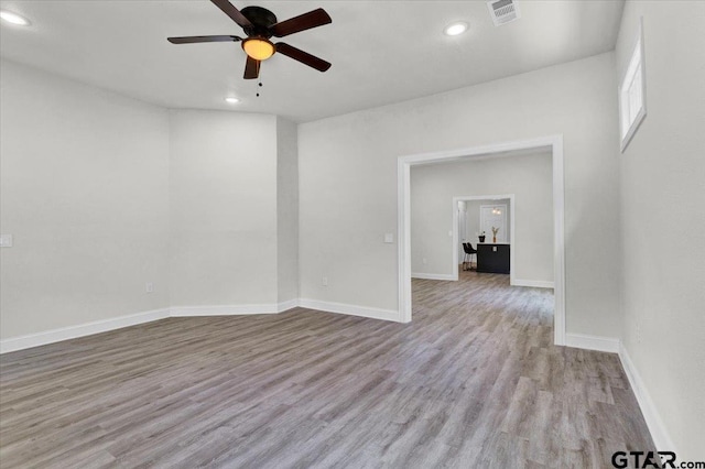 spare room with ceiling fan and light hardwood / wood-style flooring