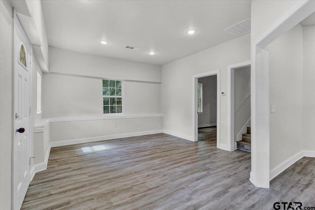 254 SE 19th St, Paris, TX 75460 - empty room featuring wood finished floors, stairs, baseboards, and recessed lighting