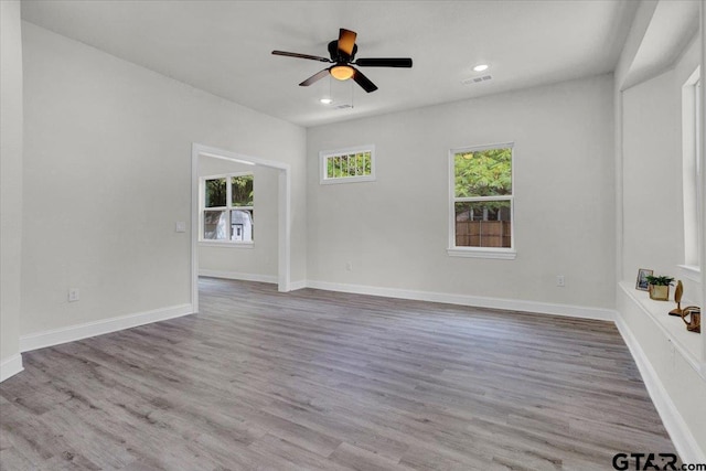 unfurnished room with ceiling fan and light hardwood / wood-style floors