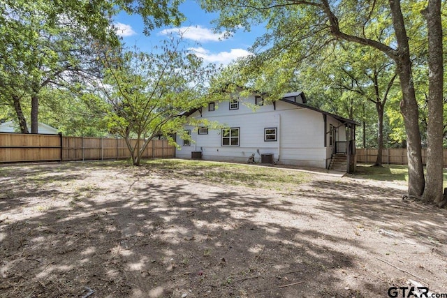 rear view of property with central AC unit