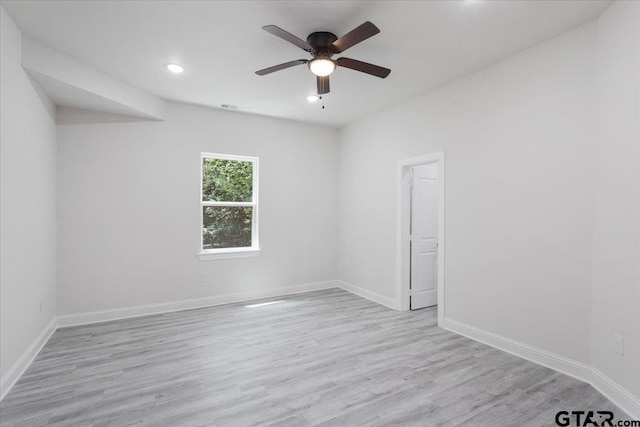 spare room with ceiling fan and light hardwood / wood-style floors