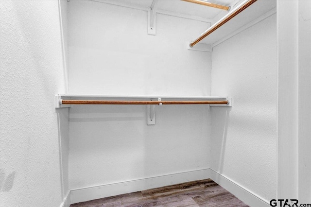 walk in closet with hardwood / wood-style floors