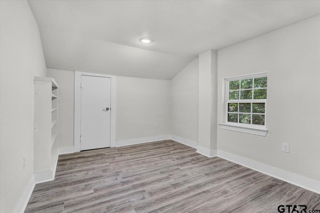 bonus room featuring light hardwood / wood-style floors and lofted ceiling