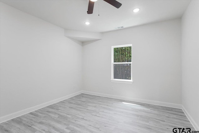 empty room featuring light wood-type flooring and ceiling fan