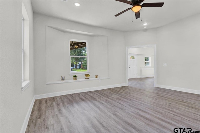 unfurnished room featuring light hardwood / wood-style floors and ceiling fan