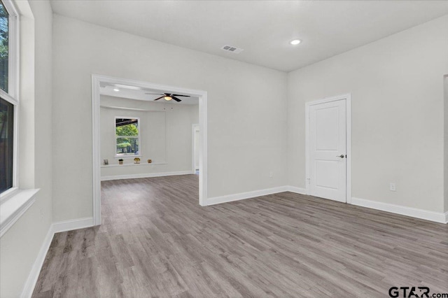 unfurnished room featuring light wood-type flooring and ceiling fan