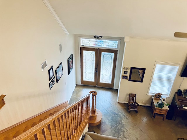 entrance foyer featuring ornamental molding and french doors