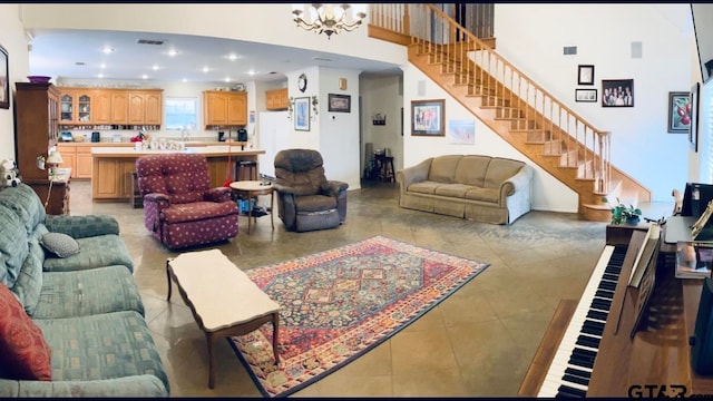 living room with a notable chandelier and light tile patterned flooring