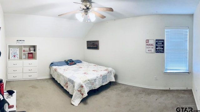 bedroom featuring ceiling fan, light colored carpet, and vaulted ceiling