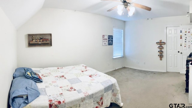 carpeted bedroom featuring ceiling fan and vaulted ceiling