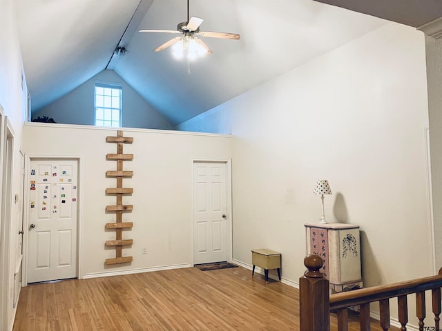 entryway featuring ceiling fan, light wood-type flooring, and lofted ceiling