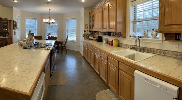 kitchen with tile countertops, white dishwasher, crown molding, and sink