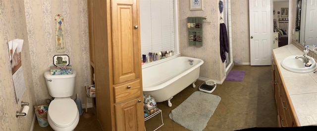 bathroom featuring a bathing tub, vanity, and toilet