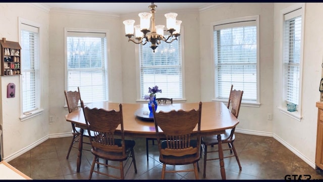 dining room featuring plenty of natural light, a chandelier, and ornamental molding